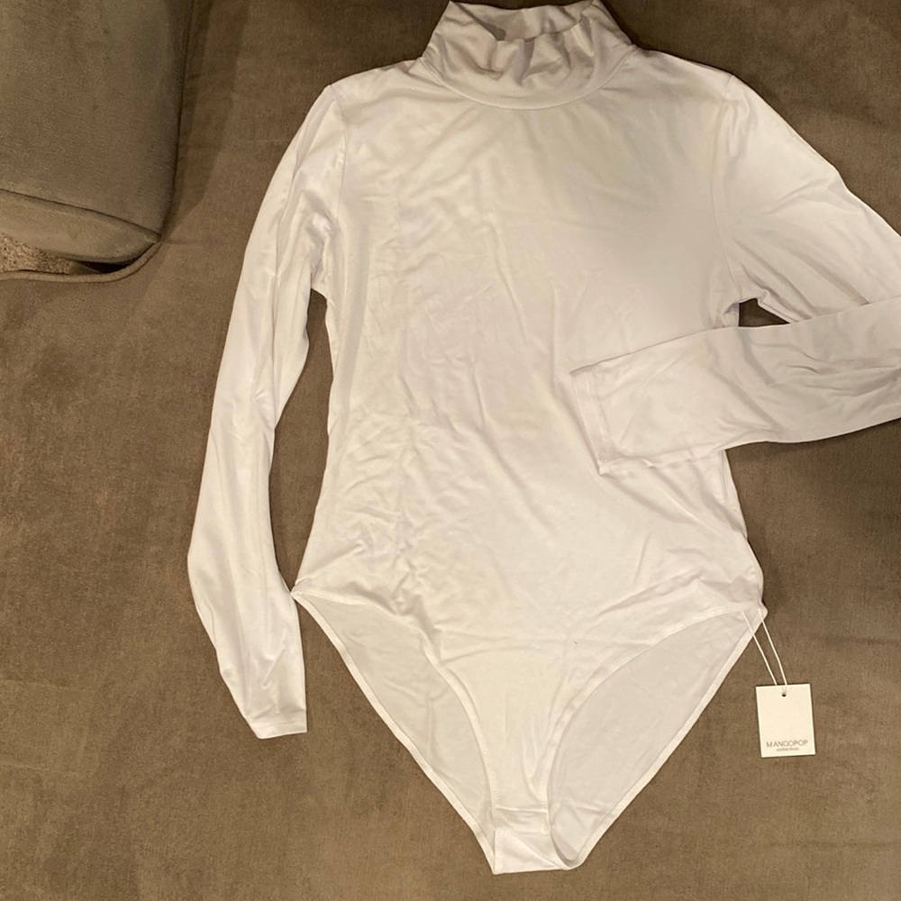 White mock neck, long sleeved bodysuit.